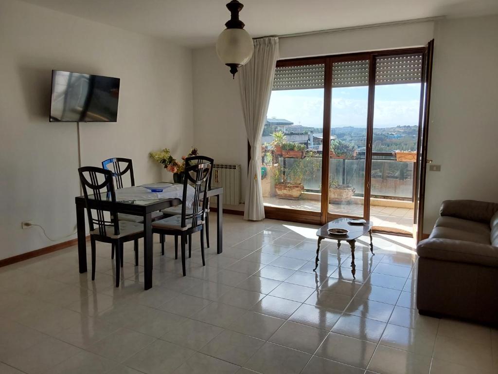 salon ze stołem, krzesłami i kanapą w obiekcie Appartamento In residence w mieście Perugia