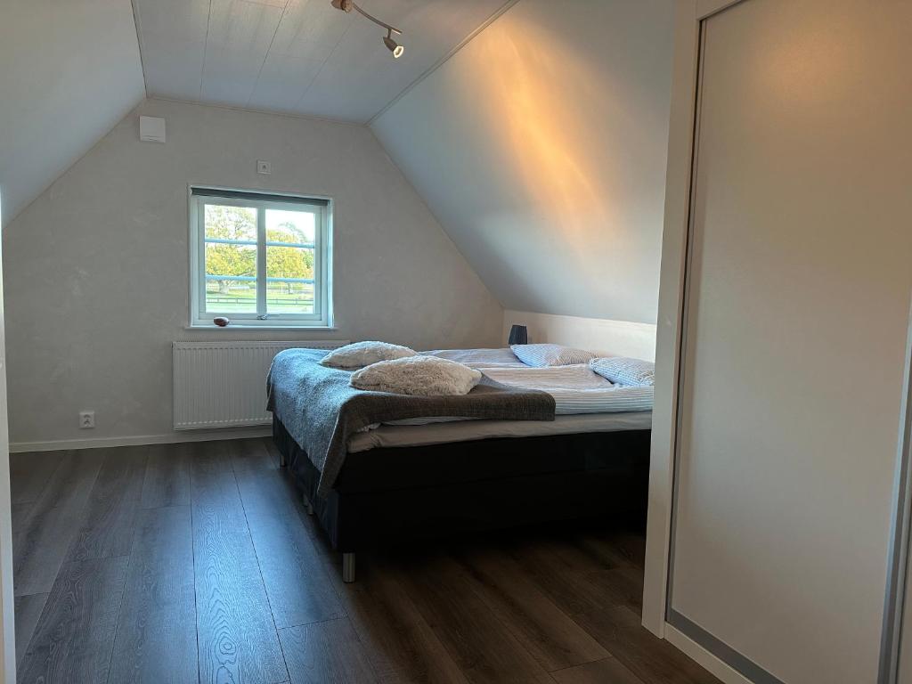 a bedroom with a bed in a attic at Yngsjövång in Yngsjö