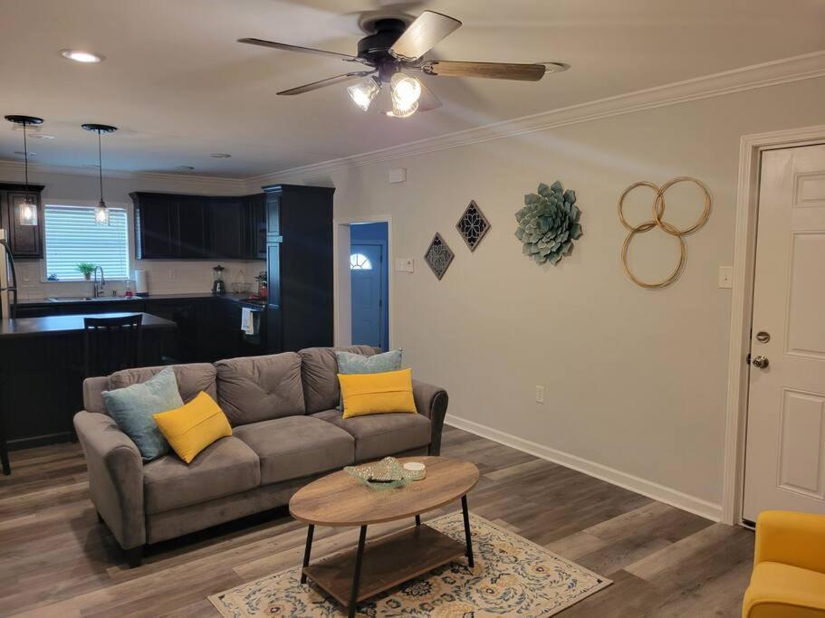a living room with a couch and a table at Cottage in Downtown Houma in Houma