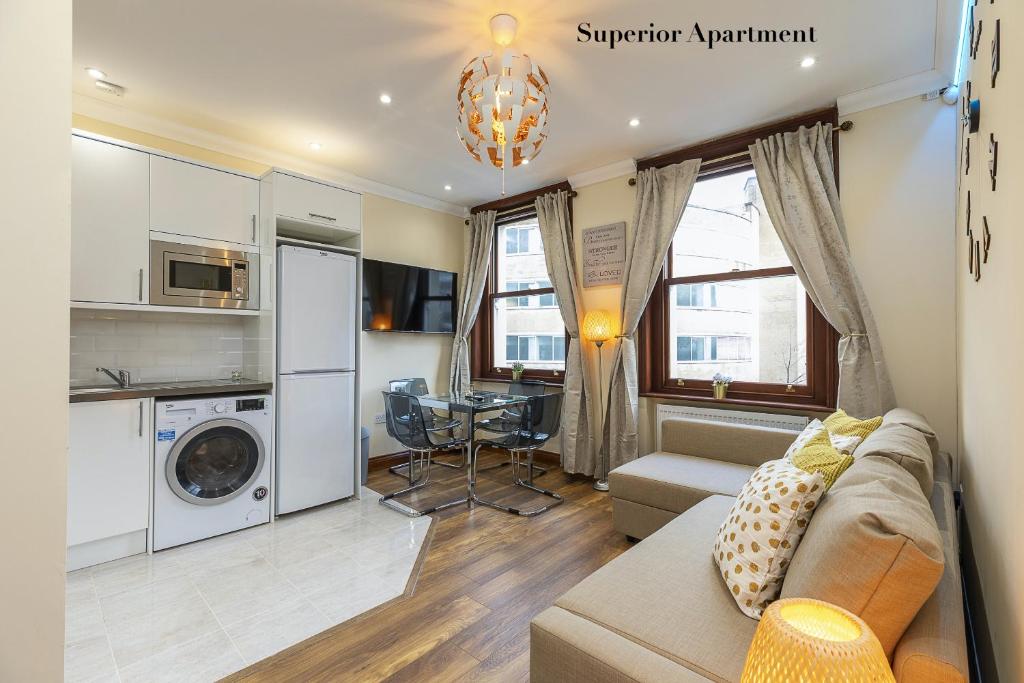 a living room with a couch and a table in a room at Stylish Apartment Kensington in London