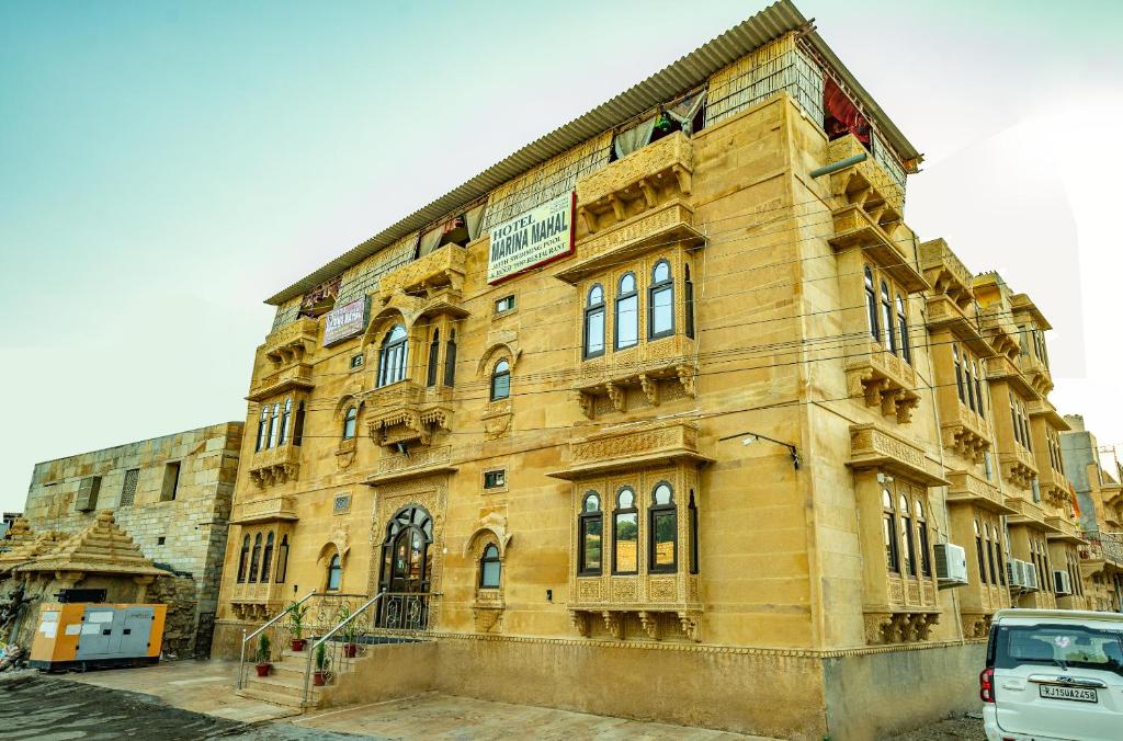 a yellow building with a sign on the side of it at Hotel Marina Mahal with Swimming Pool in Jaisalmer