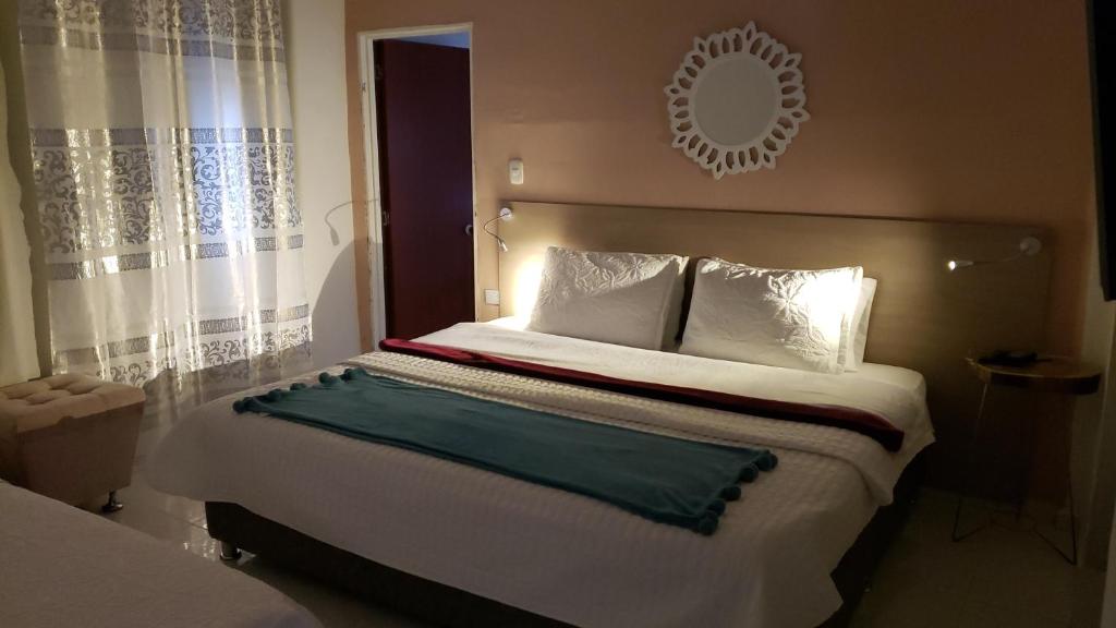 a bedroom with a large bed with a mirror on the wall at Mirador San Jose in Santa Rosa de Cabal