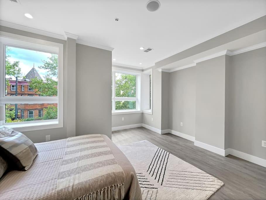 a bedroom with a large bed and two windows at Modern Meridian 2 Bedroom (Chapin 3) in Washington, D.C.