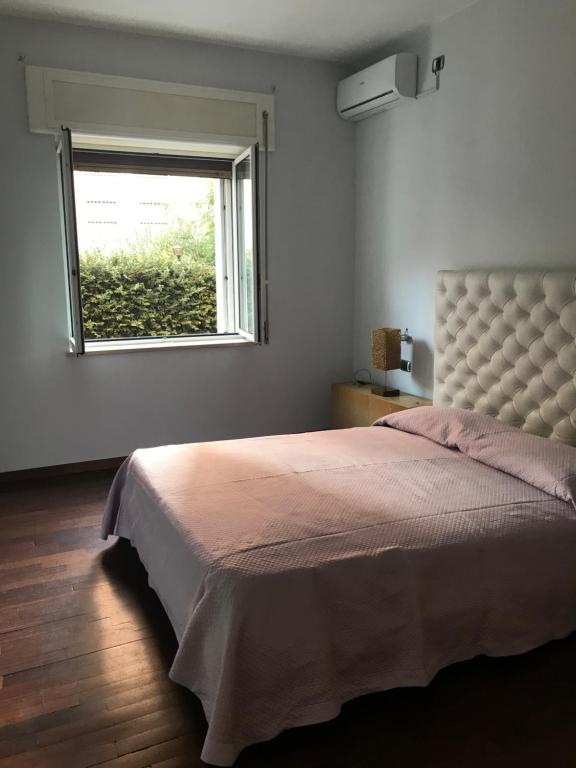 a bedroom with a large bed and a window at Casa Vacanze Ily ai Colli in Naples