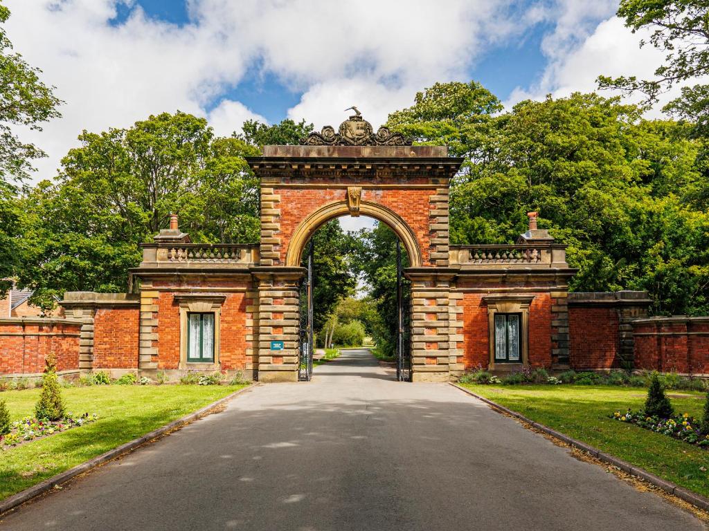 an entrance to a brick building with an archway at Lytham Hall Gate House in Lytham St Annes