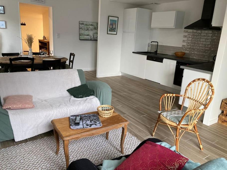 a living room with a couch and a table at Gîte Ty Guen à Paimpol in Paimpol