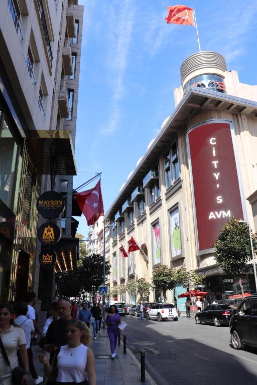 a group of people walking down a street in a city at Mas Suites Nisantasi in Istanbul