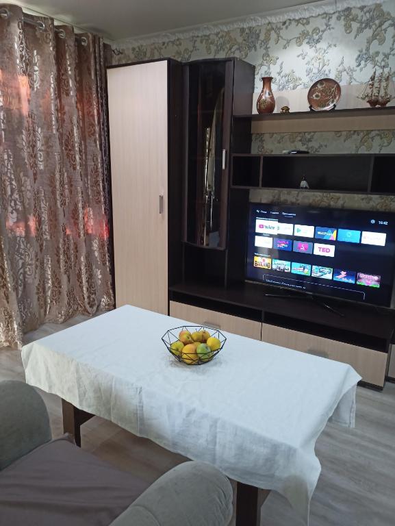 a bowl of fruit on a table in a living room at Площадь in Qyzylorda