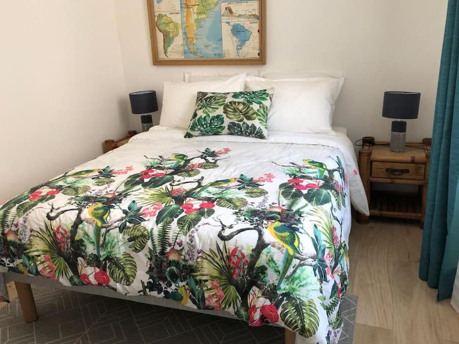 a bedroom with a bed with a colorful bedspread at Cannes centre-deux pièces-tout confort in Cannes