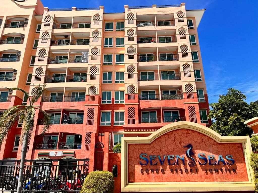a large building with a sign in front of it at Seven Seas Condo Resort Jomtien Loft in Jomtien Beach