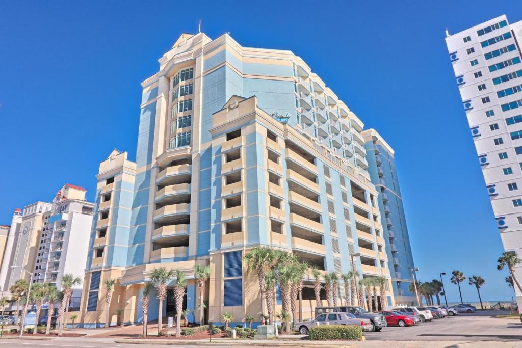 a tall building with palm trees in front of it at Captivating oceanfront condo, with great views, Beachfront building, wifi and po in Myrtle Beach