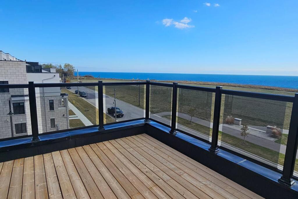 a balcony with a view of the ocean at Lakehouse with Rooftop View in Bowmanville