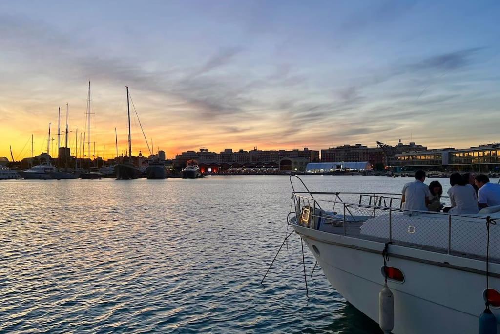 a group of people sitting on a boat in the water at Ciudad y playa desde un barco. in Valencia