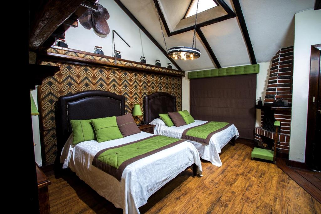 Postel nebo postele na pokoji v ubytování Hosteria Rumipamba De Las Rosas