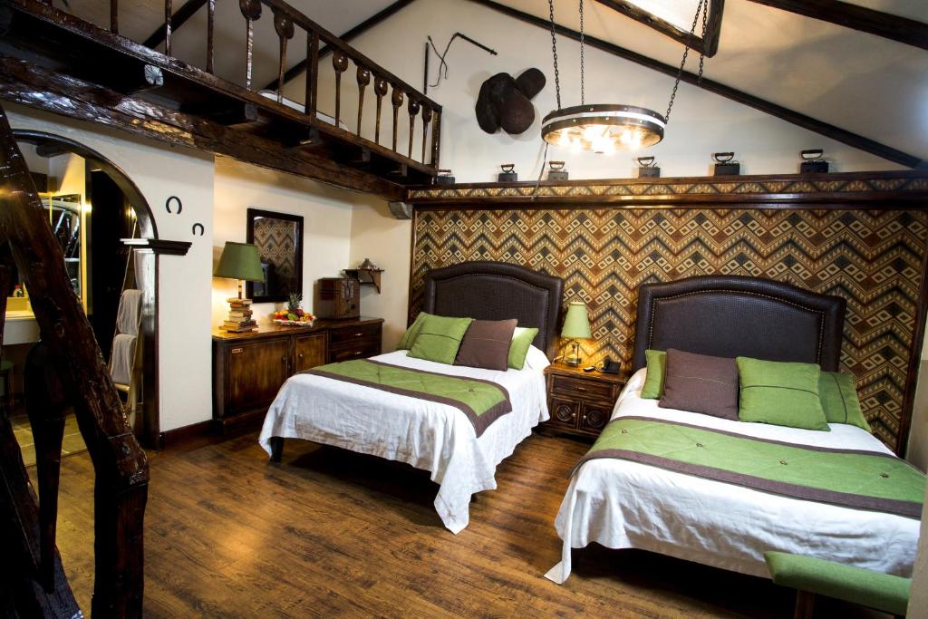 Postel nebo postele na pokoji v ubytování Hosteria Rumipamba De Las Rosas