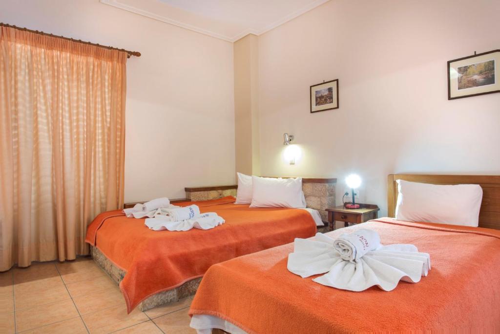 Postel nebo postele na pokoji v ubytování Aktaion Hotel