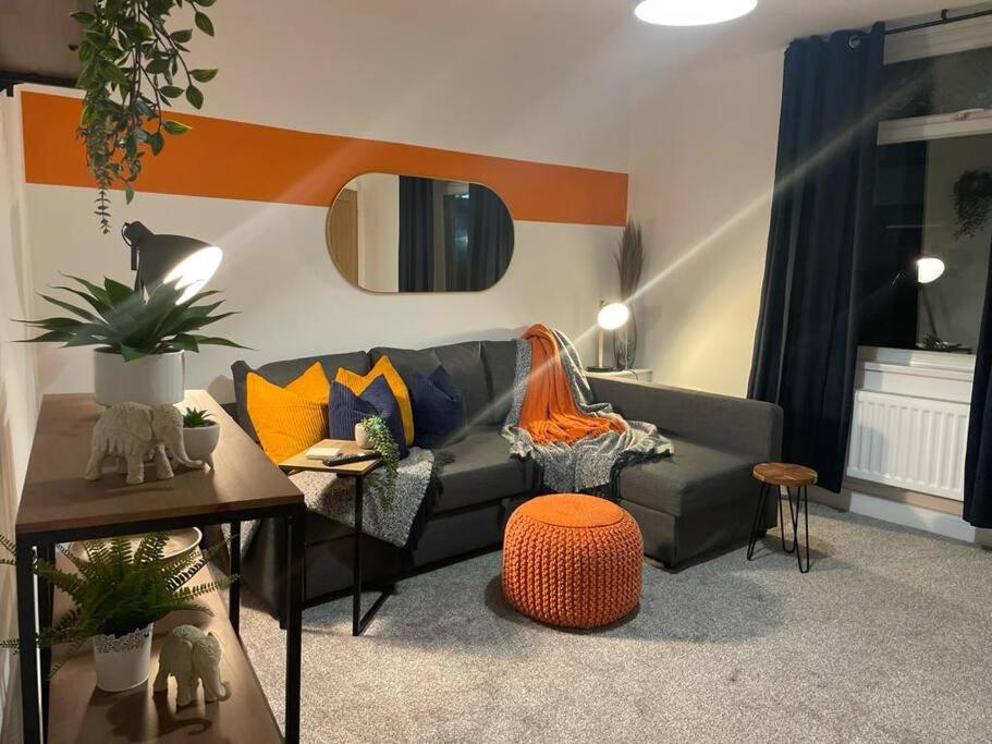 a living room with a couch and a table at Pentrebach House by M-GroupSA in Troed-y-rhiw