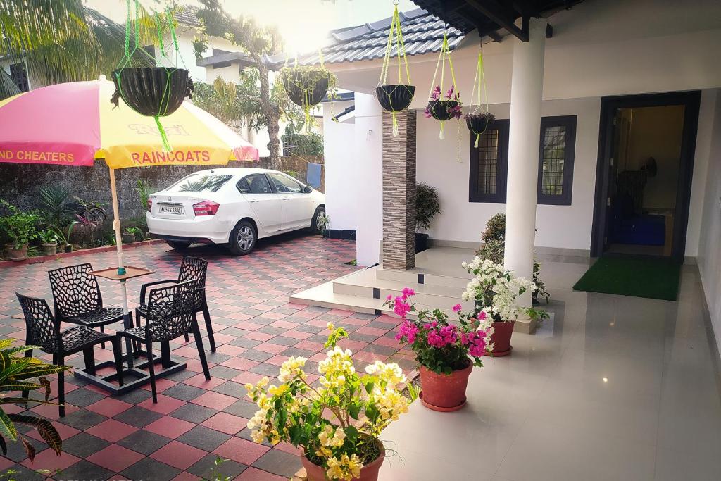 a white car parked in front of a house at Vythiri Garden in Vythiri