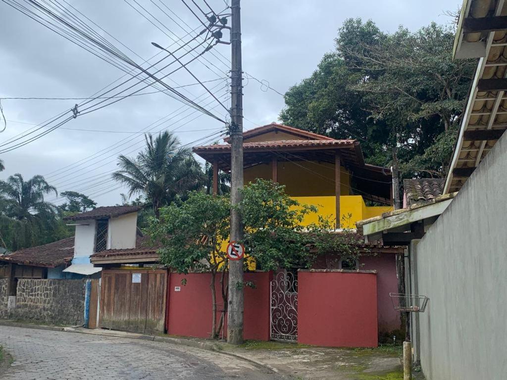 a house on the side of a street at Apartamentos com cachoeira no quintal in Ilhabela