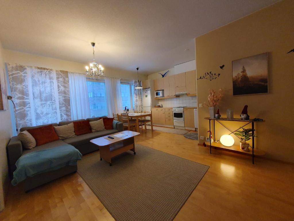 a living room with a couch and a table at Rovaniemi Ruokasenkatu apt - Wi-Fi - Sauna - Free Parking in Rovaniemi