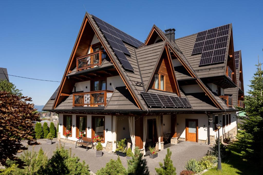 a house with solar panels on its roof at Willa Gielatówka in Białka Tatrzańska