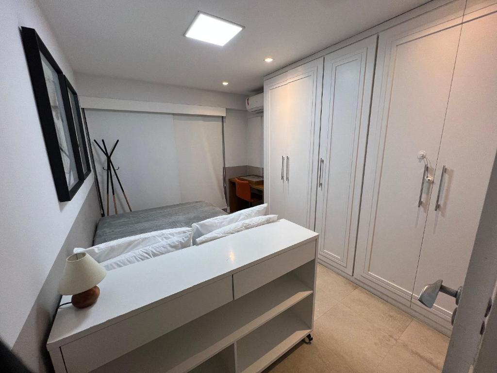 a bedroom with a bed and a white cabinet at Ipanema Flat - Vieira Souto 500 in Rio de Janeiro