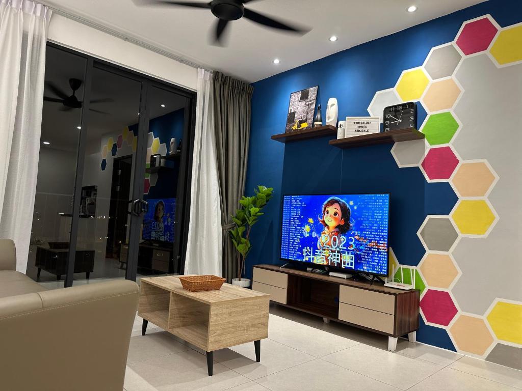 a living room with a flat screen tv on a blue wall at Wanderlust Homes @ Armadale Residence in Kuching
