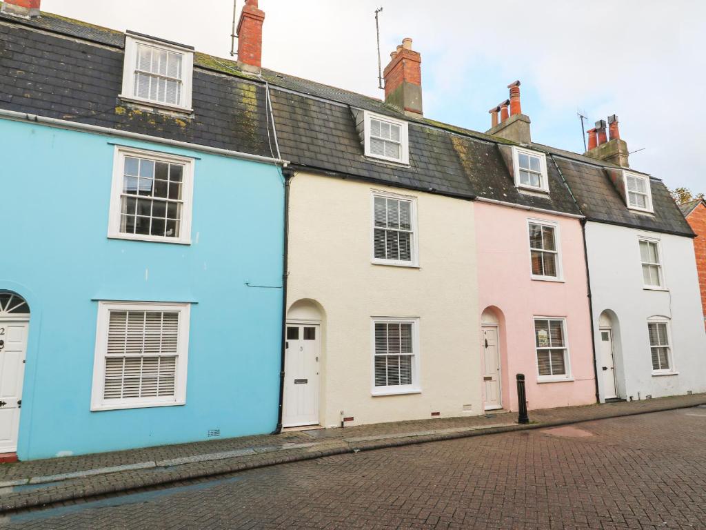 une rangée de maisons blanches dans une rue dans l'établissement Harbour Tales, à Weymouth