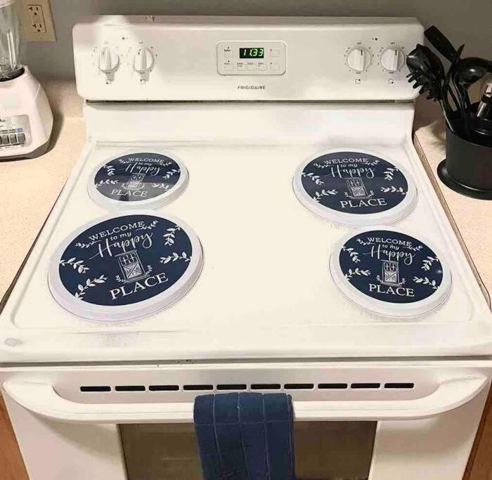 a white stove with three plates on top of it at Cozy up with me! Longer stays! Free parking in Troy