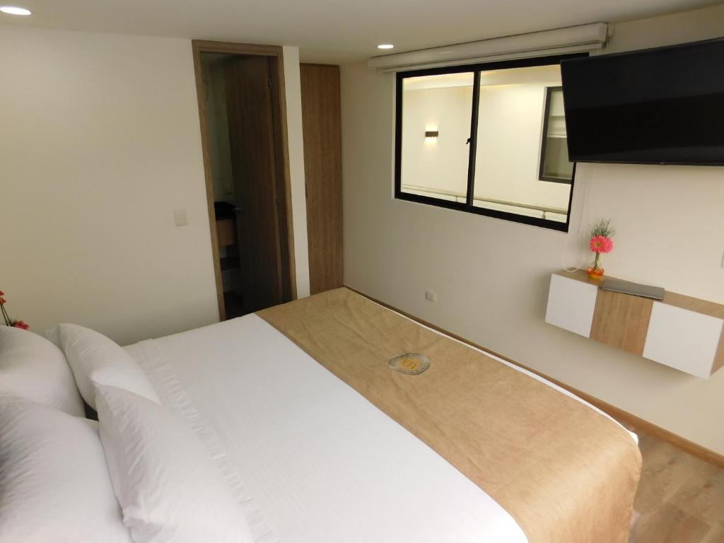 Postel nebo postele na pokoji v ubytování HOTEL MX BOGOTA