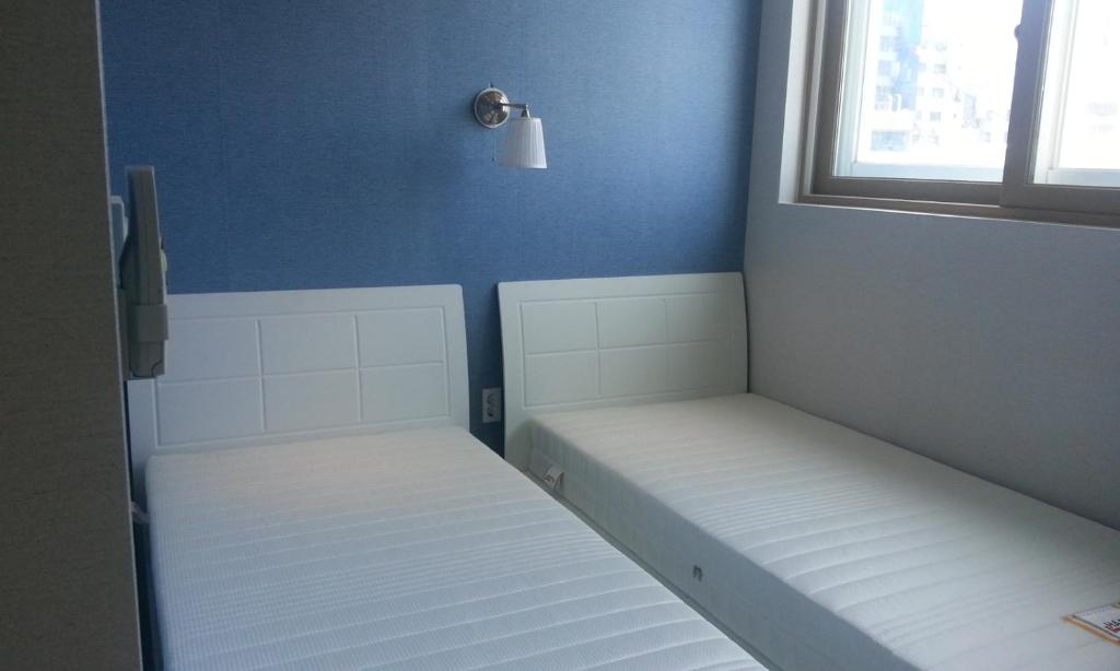Postel nebo postele na pokoji v ubytování Bexco Hostel B&B