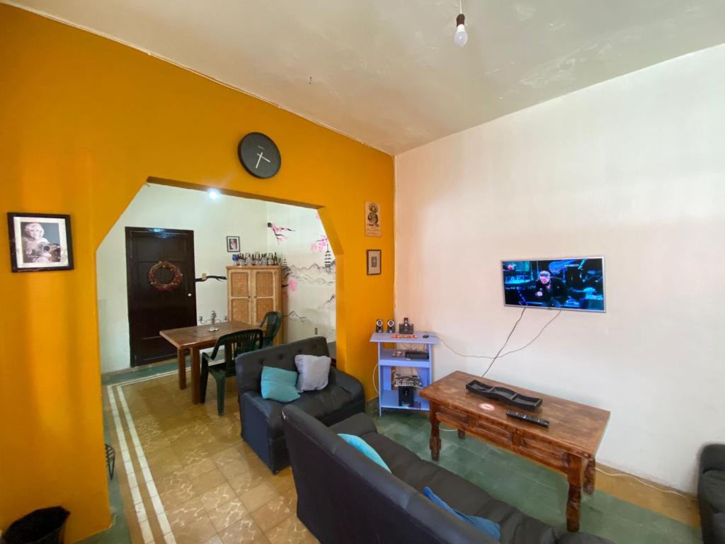 a living room with a couch and a table at ESTUDIO EN EL ZOCALO DE TLAXCALA in Tlaxcala de Xicohténcatl