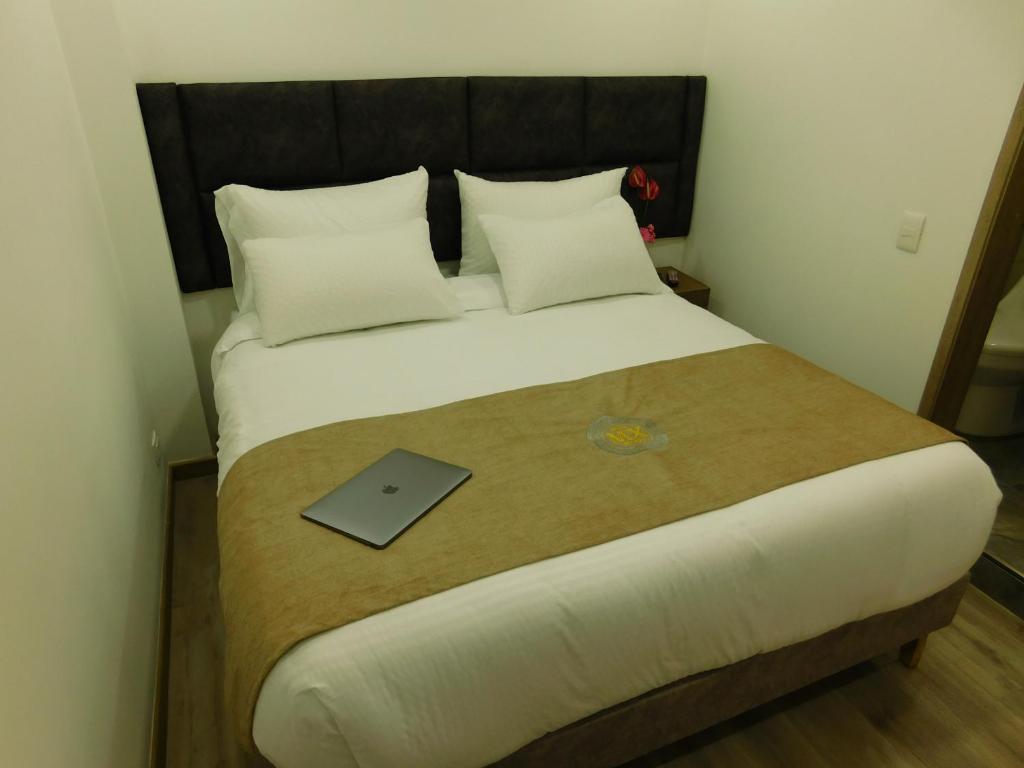 Postel nebo postele na pokoji v ubytování HOTEL MX BOGOTA