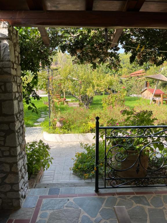 a view of a garden from the porch of a house at Maniatis Garden in Achladies