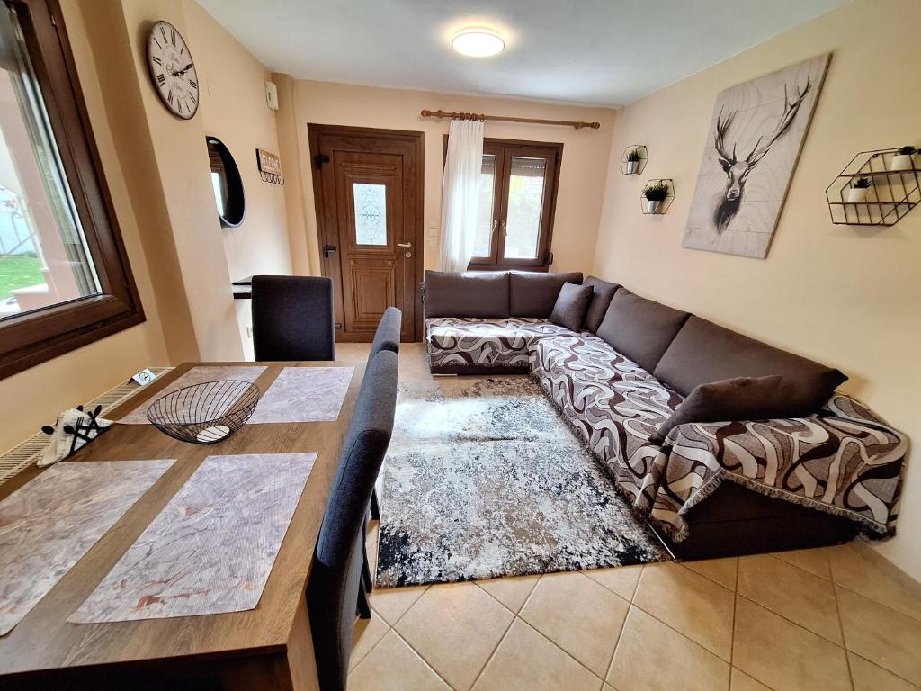 a living room with a couch and a table at Country House on Mount Olympus in Kariá