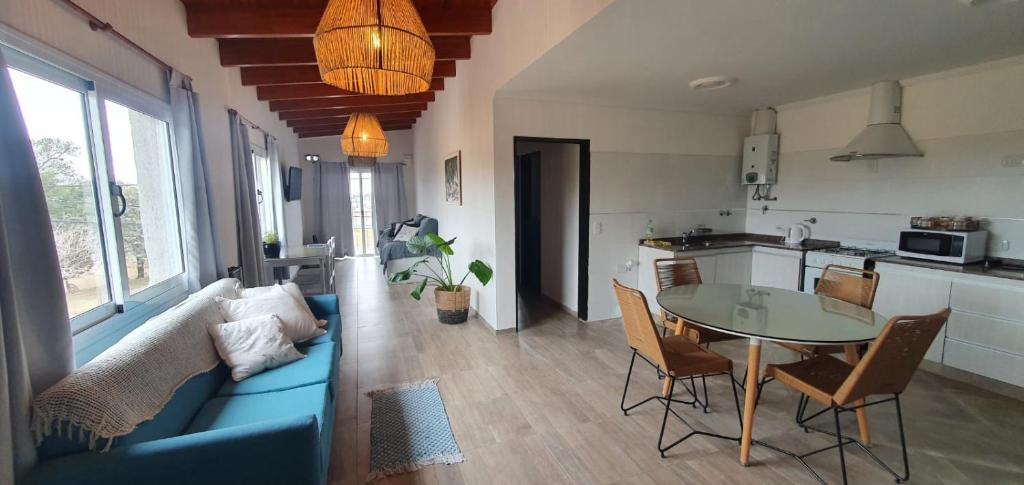 a living room with a blue couch and a table at Departamento Sinsacate in Sinsacate