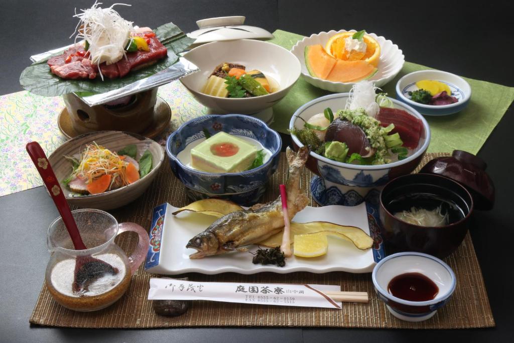 a table topped with bowls of food on a table at Teiensaryo Yamanakako in Yamanakako