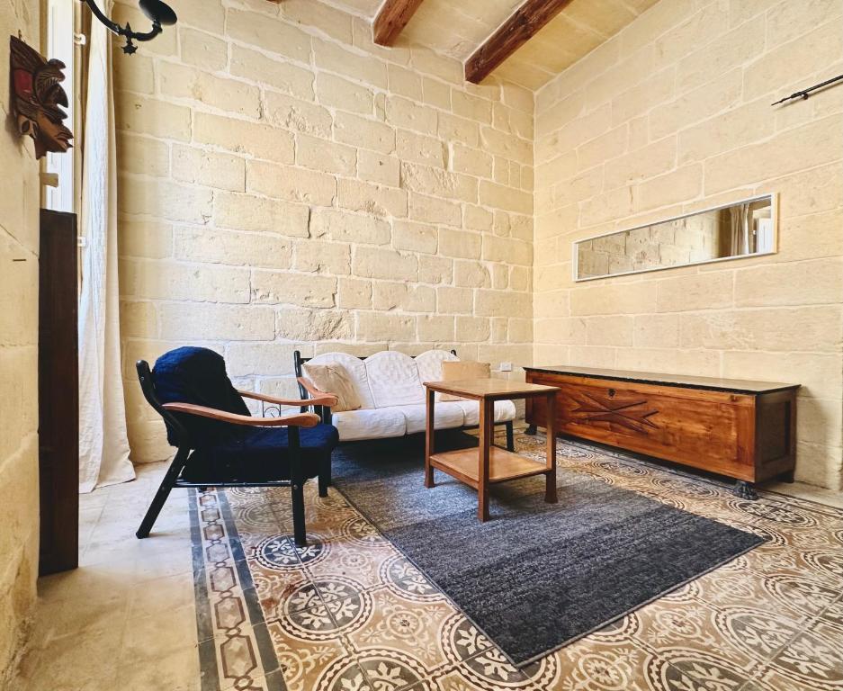 a living room with a couch and a table at Charming House in Victoria, Gozo in Victoria