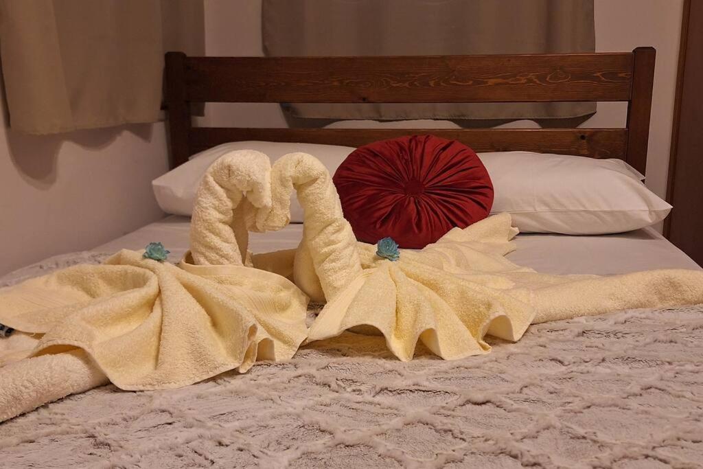 a pair of towels on a bed at Ορεινό καταφύγιο Παρνασσού in Amfikleia