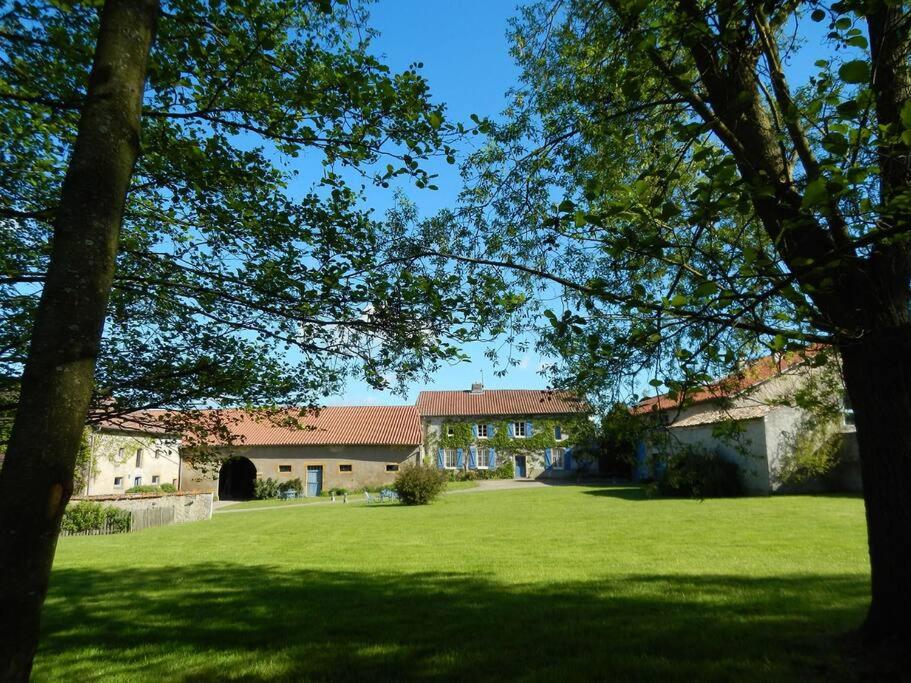 a house with a large green yard with trees at Domaine de Godchure - Gîte & Spa 