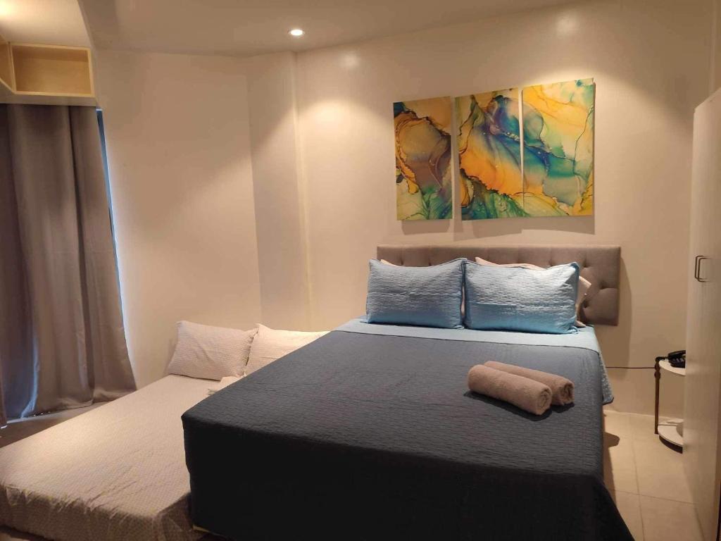 a bedroom with a bed with a towel on it at Tambuli maribago residence in Lapu Lapu City