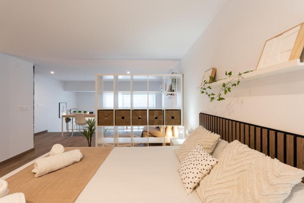 a bedroom with a large white bed in a room at SUPERB DÚPLEX with Pool & Garage in Valencia