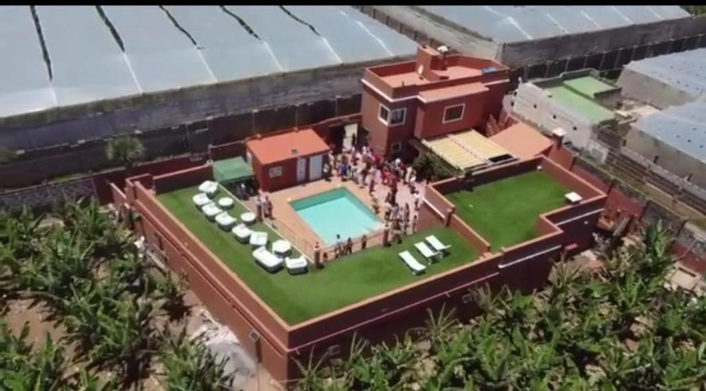 an aerial view of a house with a group of people standing on a lawn at Finca David Galdar in Las Palmas de Gran Canaria