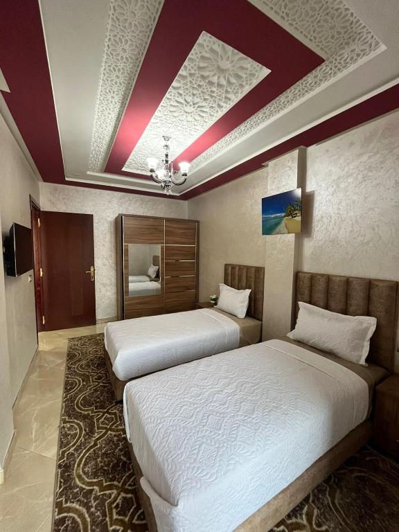 Postel nebo postele na pokoji v ubytování APPART HOTEL OUED EDDAHAB