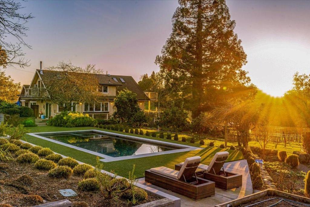 a house with a swimming pool in a yard at Charming Farmhouse Amongst The Vines in Healdsburg