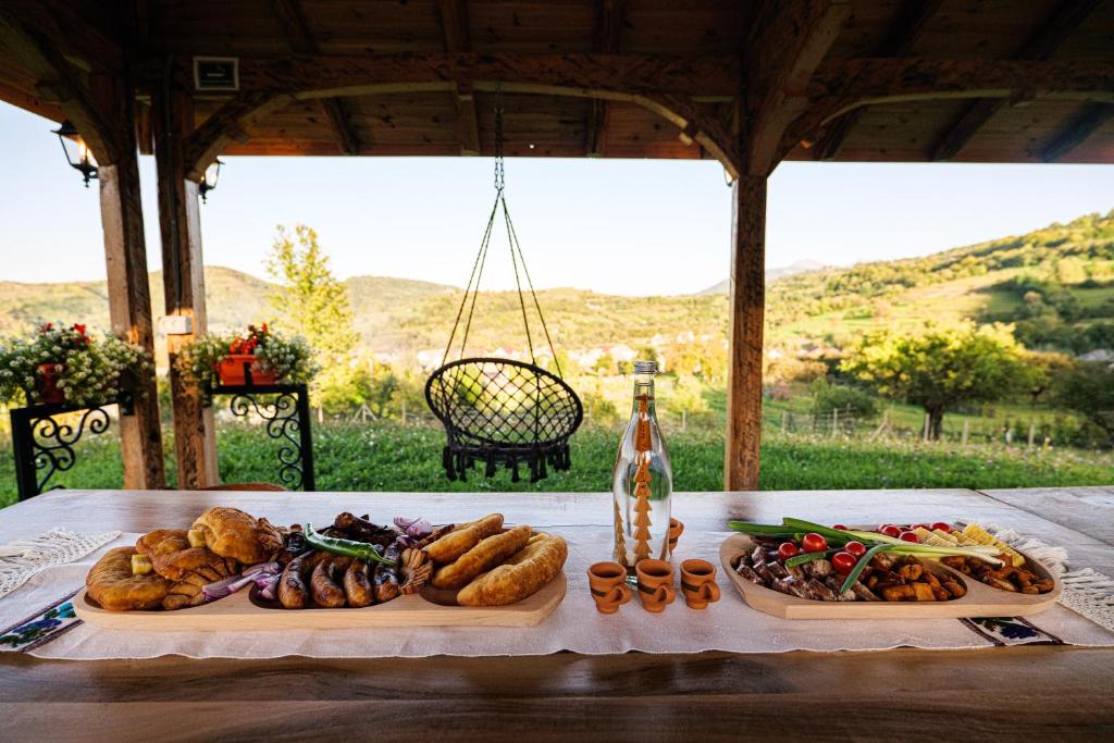 ein Tisch mit zwei Tabletten Essen drauf in der Unterkunft Casuta din Cotroape in Săcel