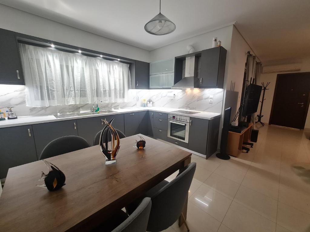 a kitchen with a wooden table with chairs and a dining room at Evi's & George's Home in Athens