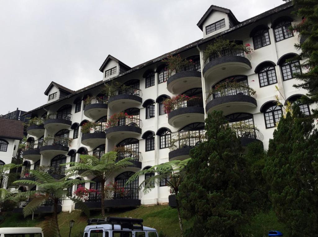 a large building with a large window overlooking a city at Strawberry Park Resort in Cameron Highlands