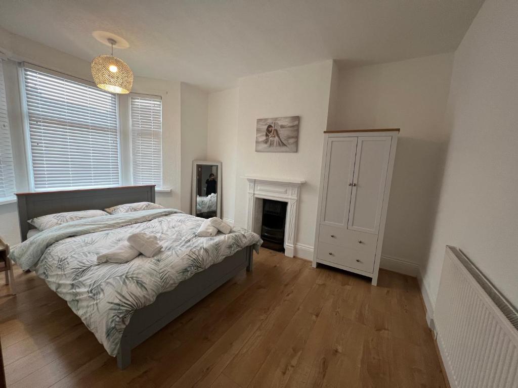 a bedroom with a bed and a fireplace in it at Victorian/modern house in Newport