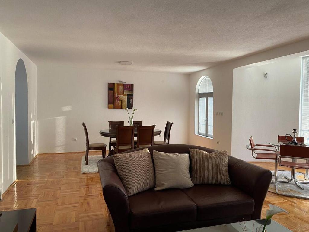 a living room with a couch and a dining room at Luxury apartment in Bitola